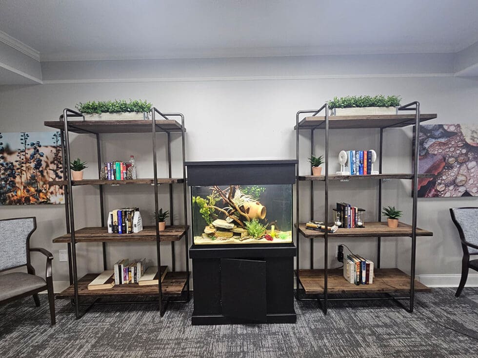 Interior common area with bookshelves and an aquarium