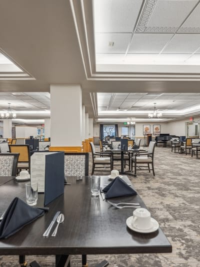 Dining room setup with tables and place settings