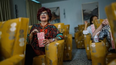 Residents enjoying a movie night with popcorn