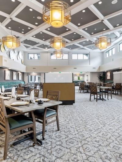 Bright dining room with tables set for residents