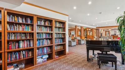 Interior view of a library and piano in a common area