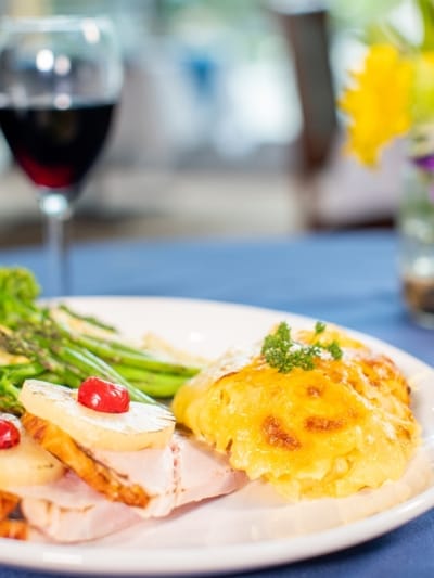 A plate of gourmet food with asparagus and wine