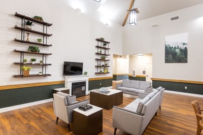 Bright common area with comfortable seating and decorative shelves