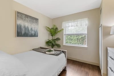 Cozy resident room with a bed and greenery