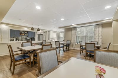 Bright common area with dining tables and kitchenette