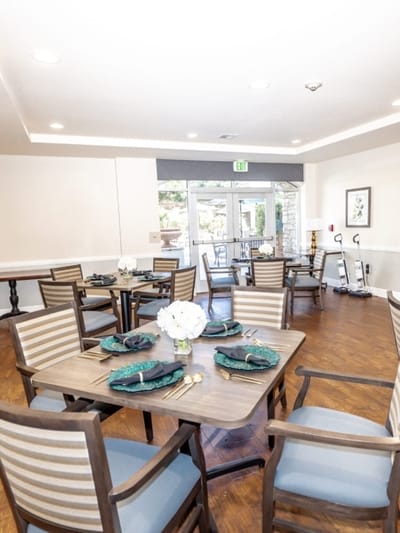 Bright dining room setup with flower centerpieces