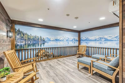 Cozy indoor seating area with a lake view mural