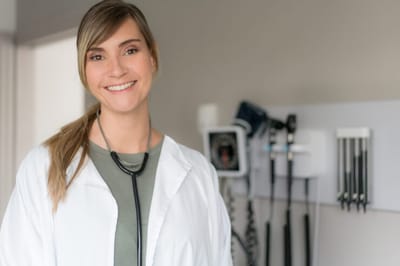 Healthcare professional smiling in a facility interior