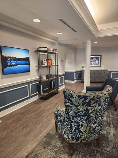 Bright common area with comfortable seating and art.