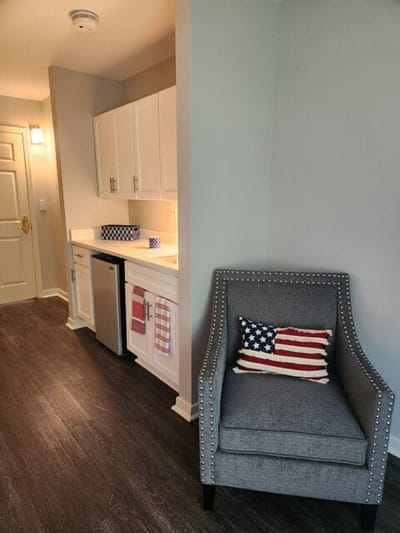 Cozy resident room with a chair and kitchenette