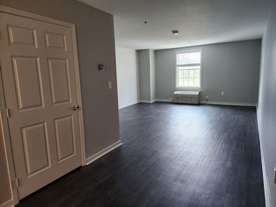 A spacious interior of a resident room with a window