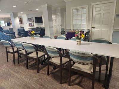 Common area with a long table and chairs