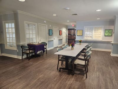 Common area with tables and chairs for activities