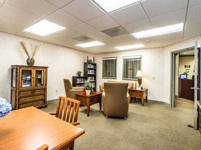 Comfortable common area with seating and bookshelves
