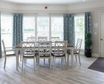 Bright dining area with a large table and chairs