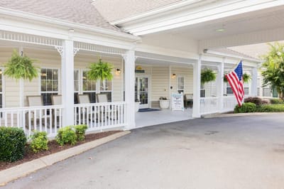 Front entrance of Charter Senior Living facility with American flag