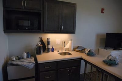 Interior kitchen area with appliances and dishes