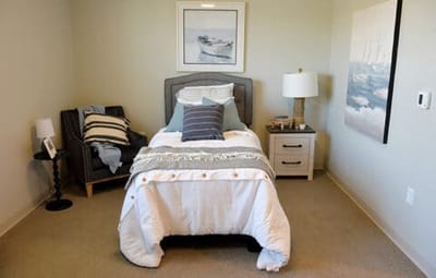 Cozy resident room with a bed and seating area