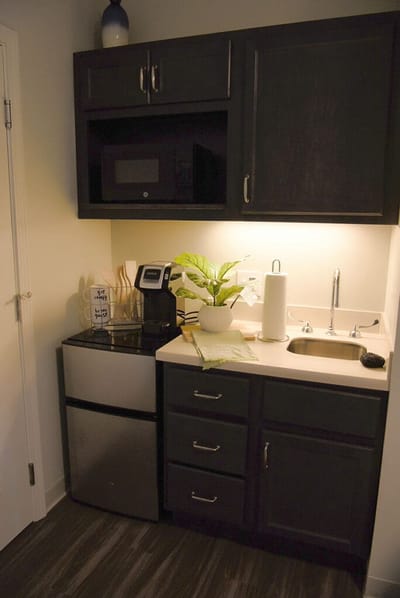 Cozy kitchenette area with coffee maker and plant