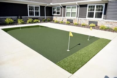 Outdoor putting green with flags in yard