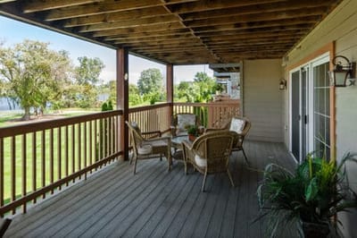 Outdoor balcony area with seating and garden view