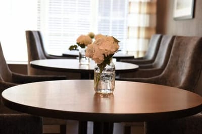Interior view of a common area with flowers on tables
