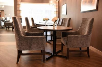 Dining area with modern chairs and flowers on the table