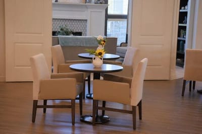 A well-furnished common area with tables and chairs