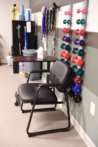 Interior fitness area with exercise equipment and chair