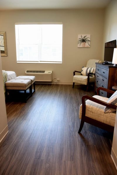 Cozy resident room with seating and natural light