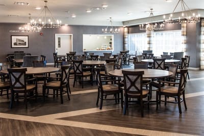 Dining room with tables and chairs in a well-lit interior