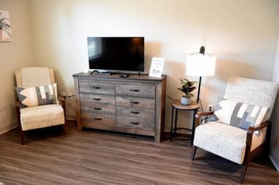 Cozy sitting area with chairs and a TV