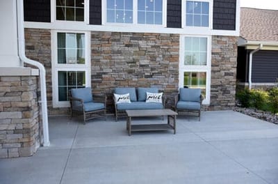 Outdoor seating area with stone wall backdrop