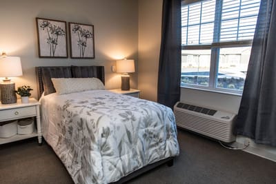 Cozy single bedroom with floral decor and natural light