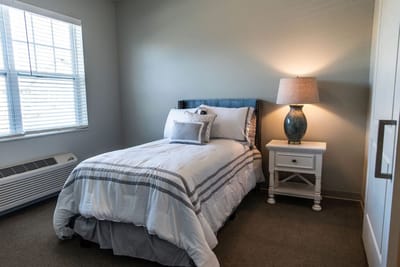 Cozy private room with a bed and lamp