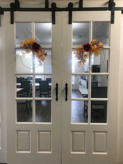 Interior doors leading to a dining area with seasonal decorations