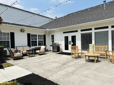 Outdoor patio area with seating and grill
