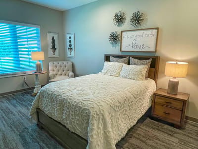 Cozy resident room with a plush bed and natural light