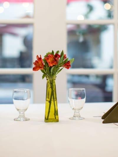 A beautifully set dining table with flowers and glassware