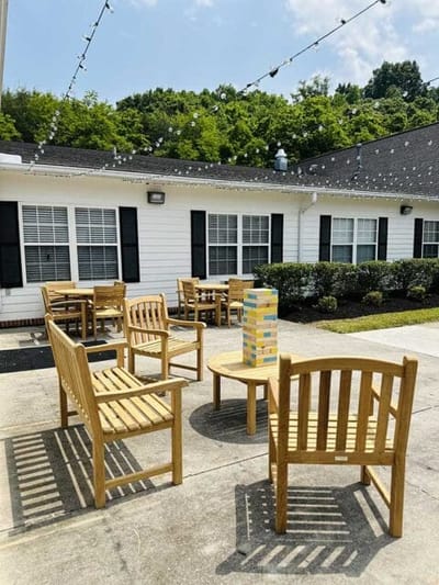 Outdoor seating area with wooden chairs and Jenga game
