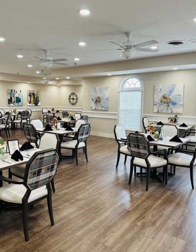 Bright dining room with tables and floral artwork