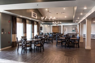 Bright dining room with tables and chairs set up