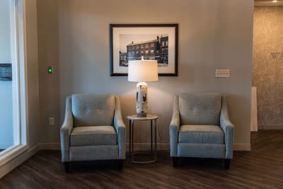 Cozy lounge area with two chairs and a lamp