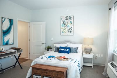 Well-decorated private resident room with cozy bedding