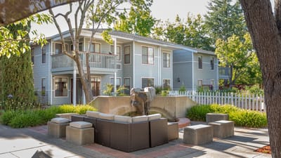 Outdoor seating area with a water feature and building in the background