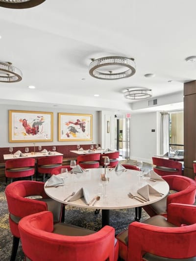 Elegant dining room setup with red chairs and tables