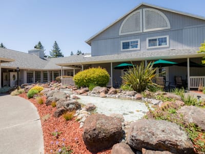 Exterior view of the assisted living facility with gardens