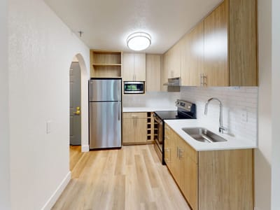 Modern kitchen interior with wooden cabinets and stainless steel appliances