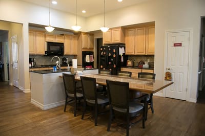 Bright dining area with a spacious kitchen setup