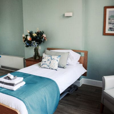 Cozy resident room with a comfortable bed and flowers